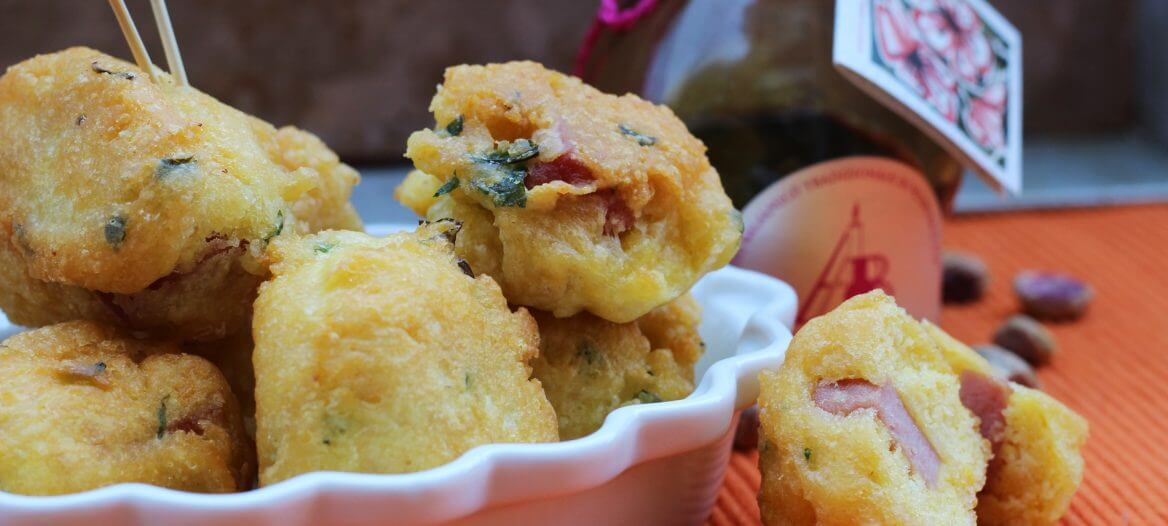 Frittelle con mortadella, aceto balsamico tradizionale e pistacchi/ Fritters with bologna, balsamic vinegar and pistachios.