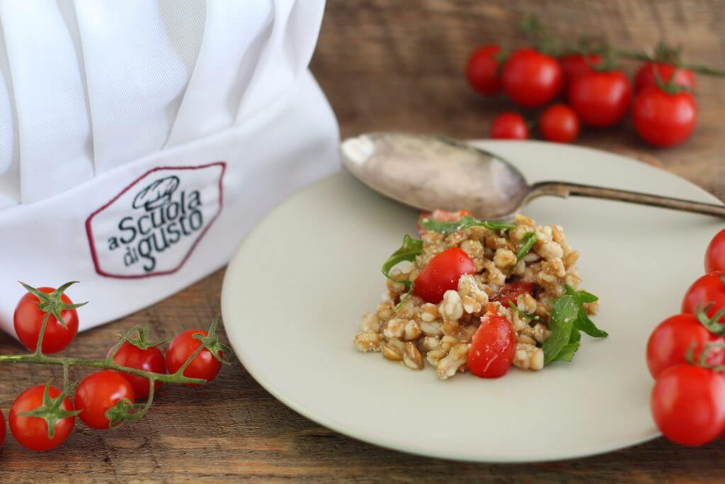 Spelt salad with cherry tomato, arugula, Parmesan and balsamic vinegar.